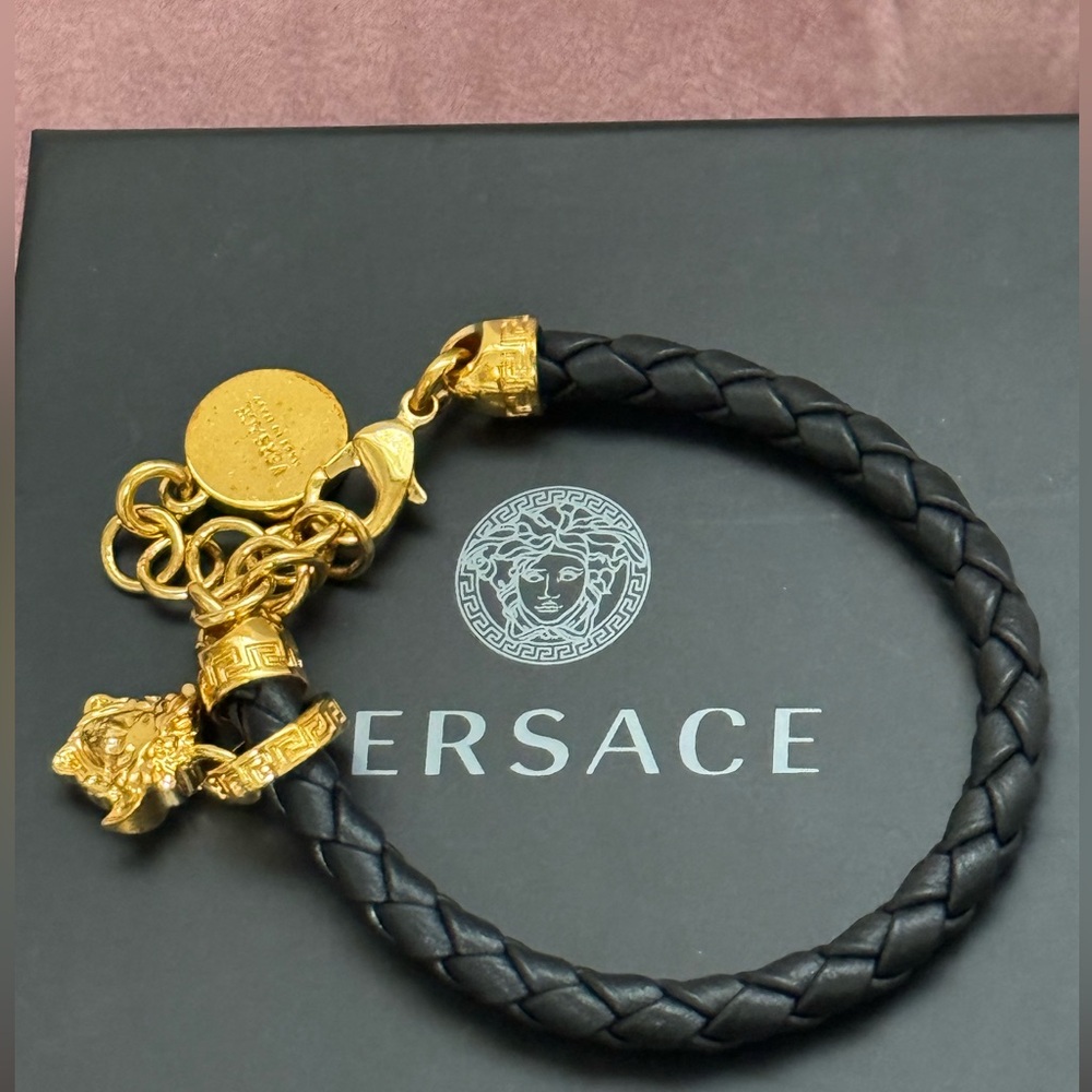 Versace medusa bracelet in black with gold.